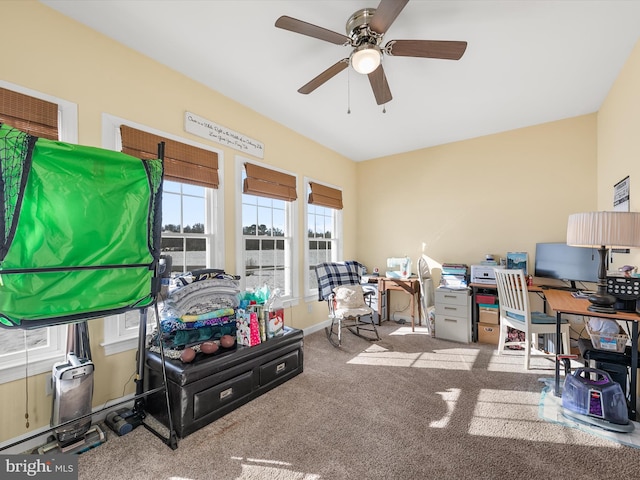 carpeted office with ceiling fan and baseboards