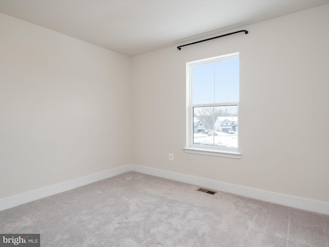 empty room featuring light colored carpet