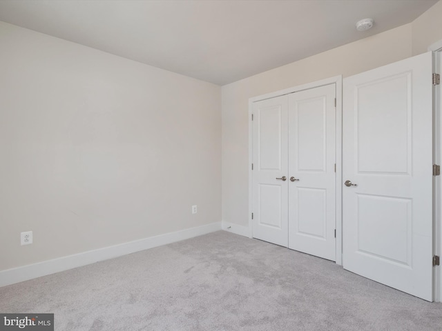 unfurnished bedroom with light carpet