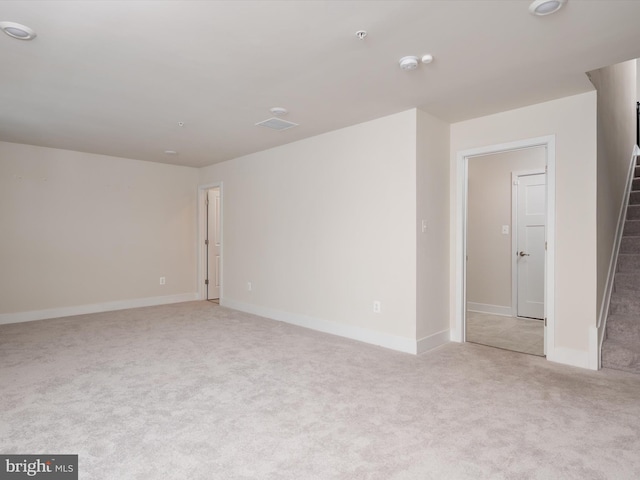 unfurnished room featuring light colored carpet