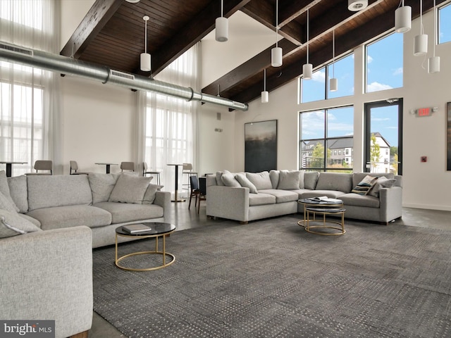 living room featuring a high ceiling, beam ceiling, and wood ceiling