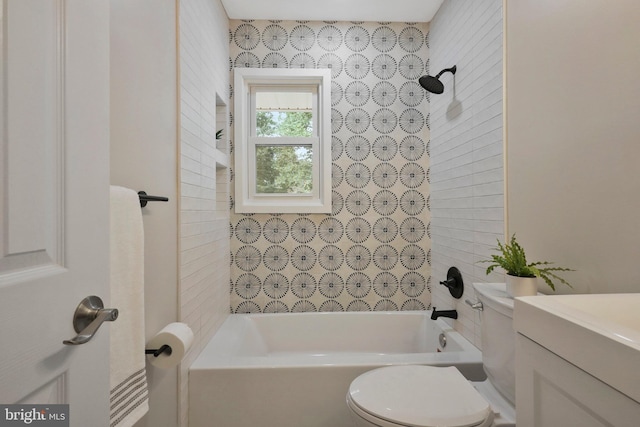 full bathroom with tiled shower / bath combo, vanity, and toilet