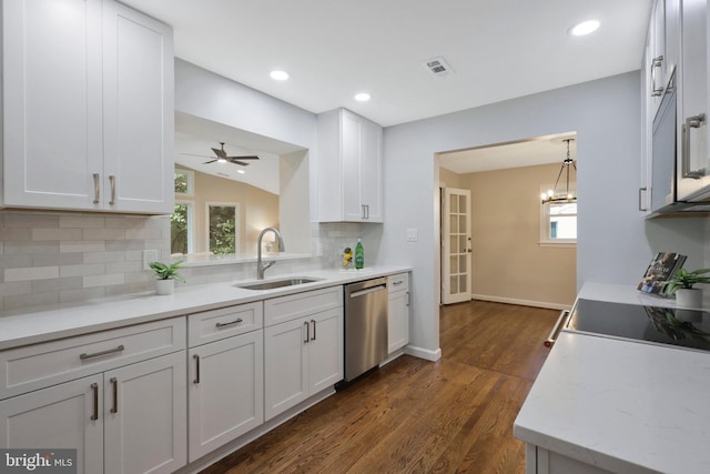 kitchen with white cabinetry, stainless steel dishwasher, sink, and backsplash