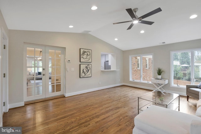 unfurnished living room with hardwood / wood-style flooring, vaulted ceiling, french doors, and ceiling fan