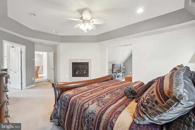 bedroom featuring ceiling fan, light carpet, and ensuite bath