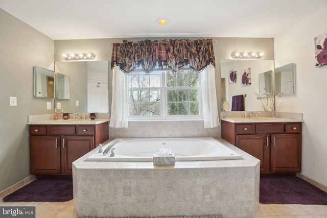 bathroom with vanity, tiled bath, and tile patterned floors