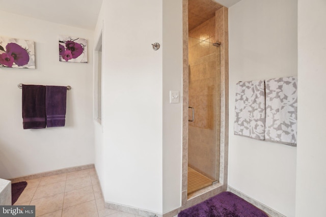 bathroom featuring an enclosed shower and tile patterned floors