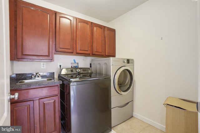 washroom featuring cabinets, independent washer and dryer, sink, and light tile patterned floors