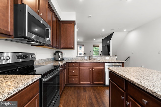 kitchen featuring dark hardwood / wood-style floors, sink, light stone countertops, and stainless steel appliances