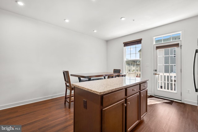 kitchen featuring dark hardwood / wood-style floors and a kitchen island