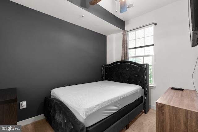 bedroom featuring light carpet and ceiling fan