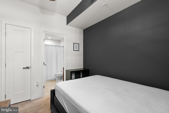 carpeted bedroom featuring ensuite bathroom