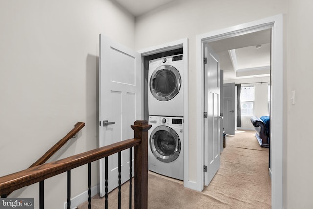 washroom featuring light carpet and stacked washer and dryer