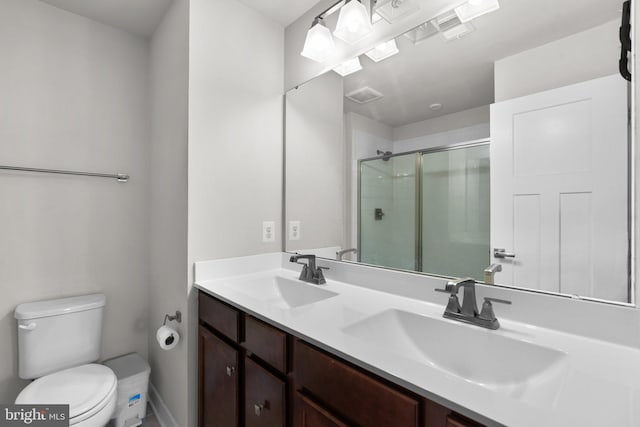 bathroom with vanity, toilet, and walk in shower