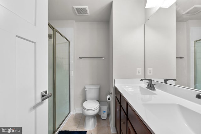 bathroom featuring toilet, tile patterned flooring, vanity, and walk in shower