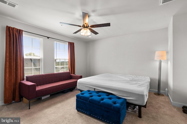 bedroom featuring light colored carpet and ceiling fan