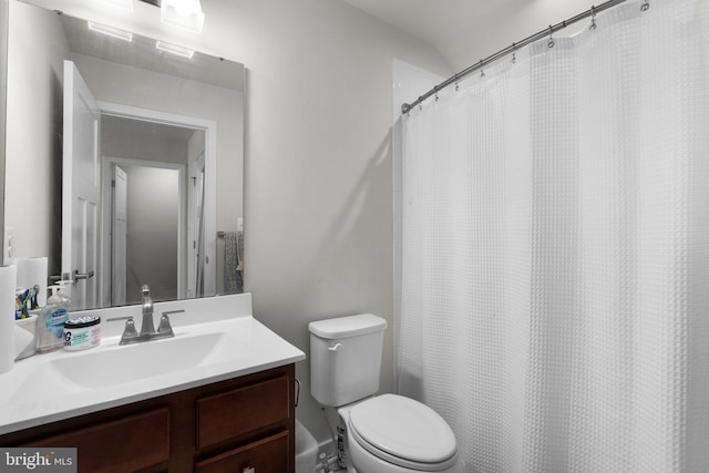 bathroom featuring vanity, a shower with shower curtain, and toilet