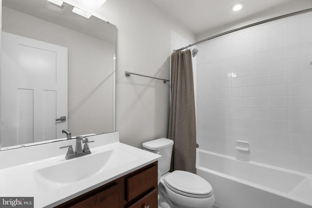 full bathroom featuring shower / tub combo with curtain, vanity, and toilet