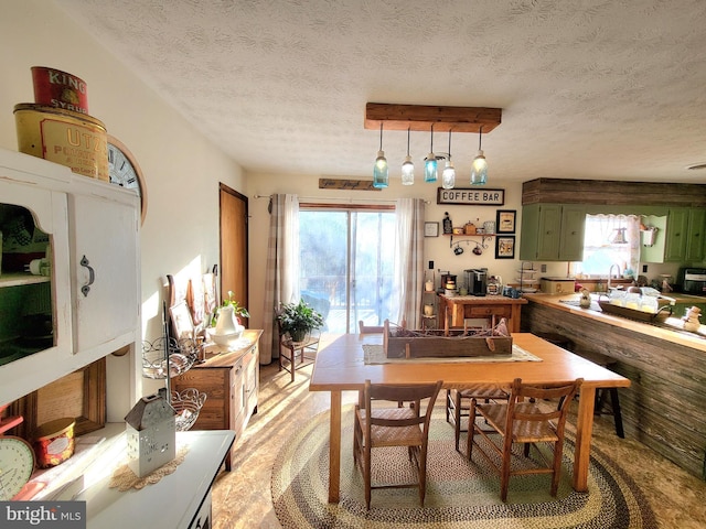 dining space featuring a textured ceiling and a wealth of natural light