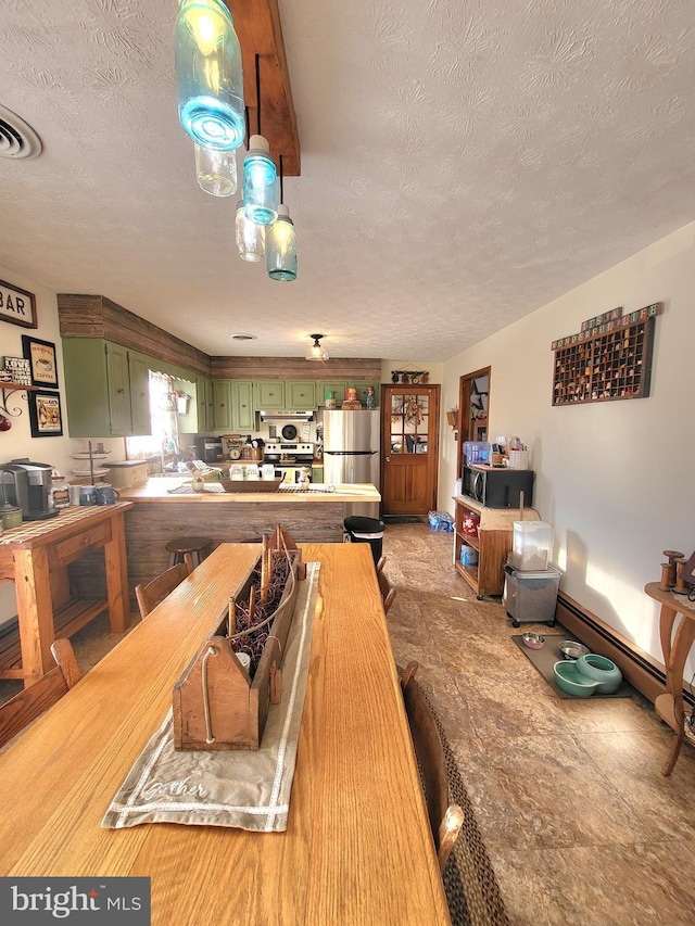 dining room featuring sink and a textured ceiling