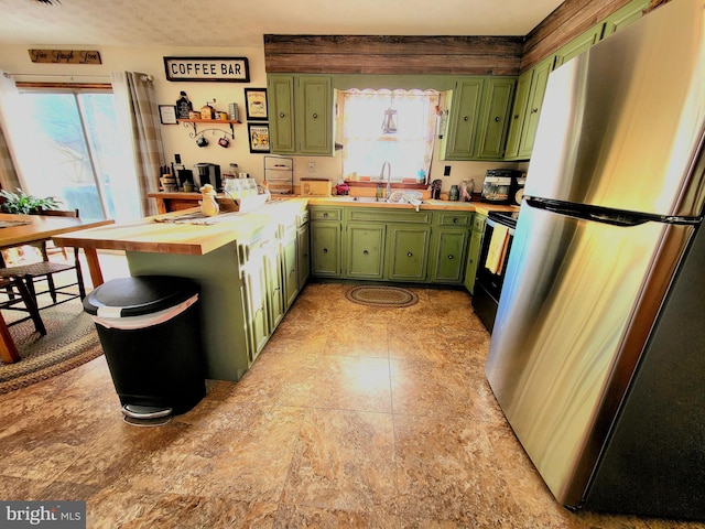 kitchen with stainless steel appliances, plenty of natural light, green cabinets, and sink