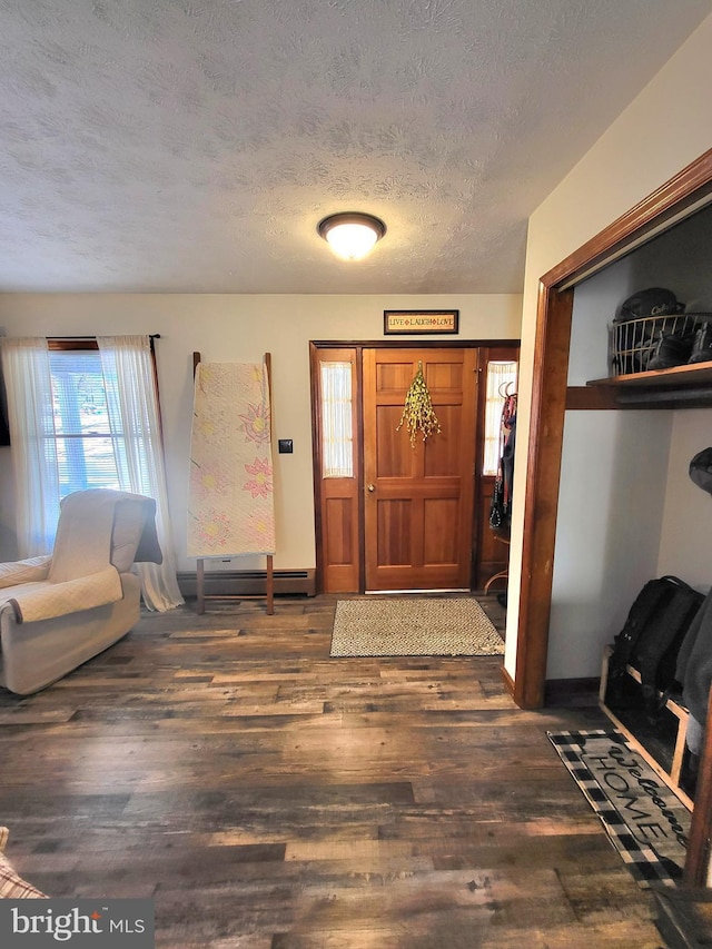 foyer featuring a textured ceiling, dark hardwood / wood-style flooring, and baseboard heating