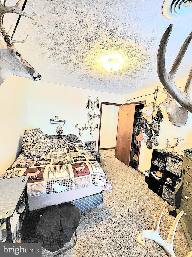 bedroom with a textured ceiling and carpet floors