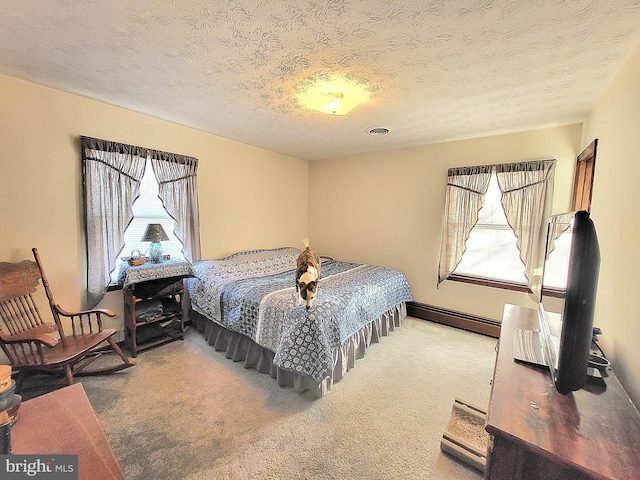 carpeted bedroom featuring a textured ceiling and a baseboard heating unit