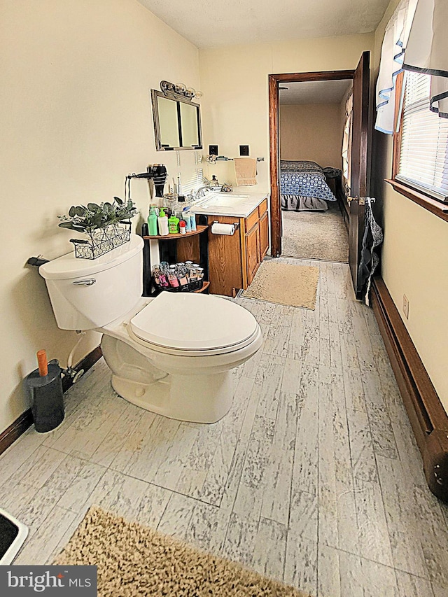 bathroom with vanity, hardwood / wood-style flooring, and toilet