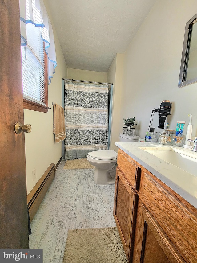 bathroom featuring hardwood / wood-style floors, vanity, toilet, a baseboard radiator, and curtained shower