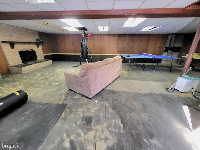 playroom with a stone fireplace, wood walls, a drop ceiling, and pool table