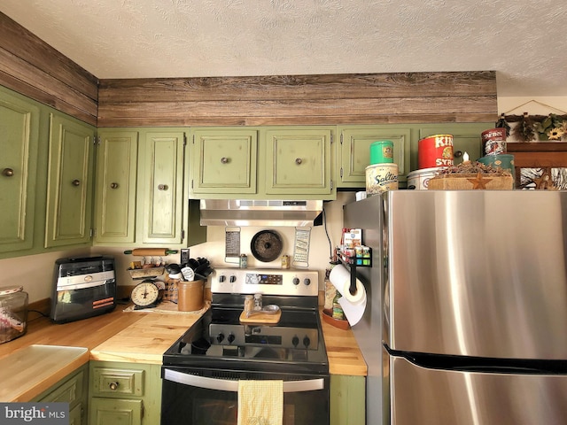 kitchen with green cabinets, stainless steel appliances, extractor fan, and wooden counters