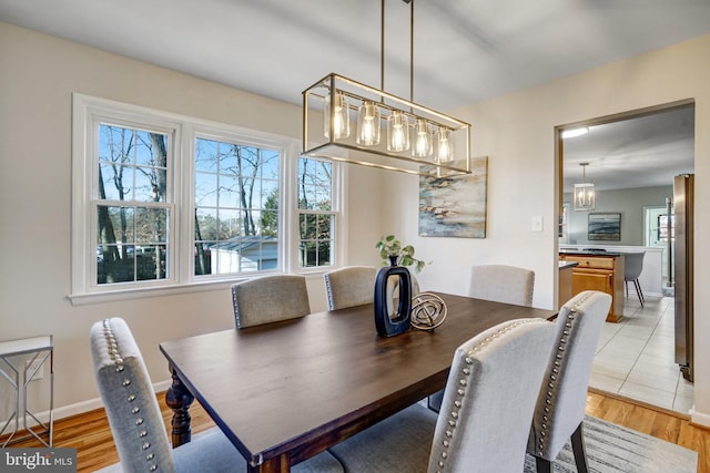 dining space featuring light wood-type flooring