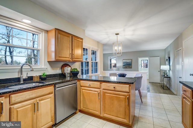 kitchen with sink, dark stone countertops, dishwasher, kitchen peninsula, and pendant lighting