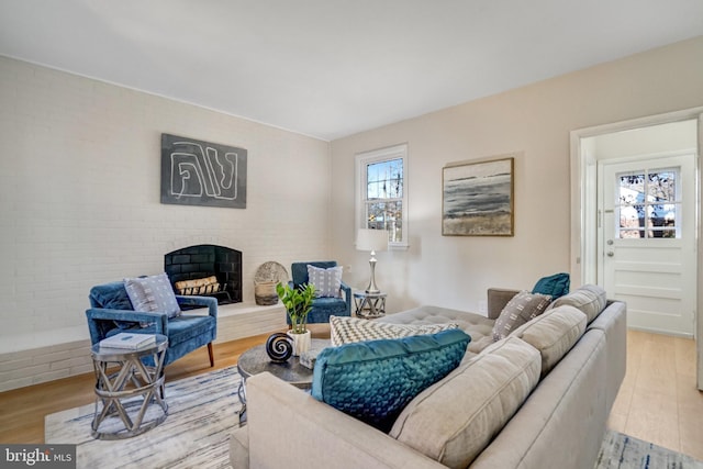 living room featuring a fireplace and light wood-type flooring