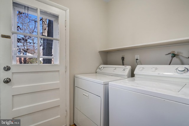 clothes washing area with separate washer and dryer