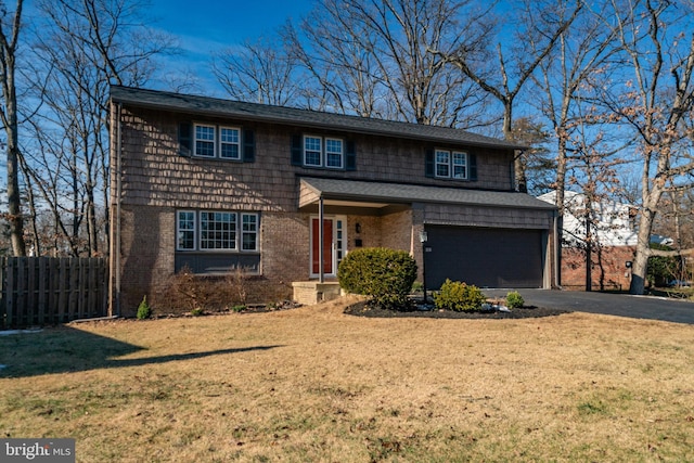 view of front of home with a garage and a front lawn