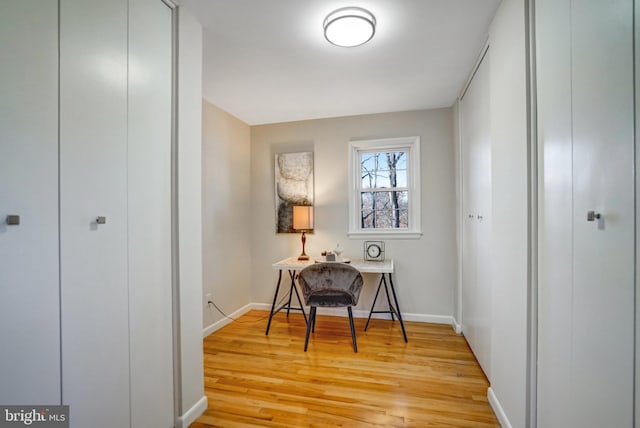 hallway with light hardwood / wood-style floors