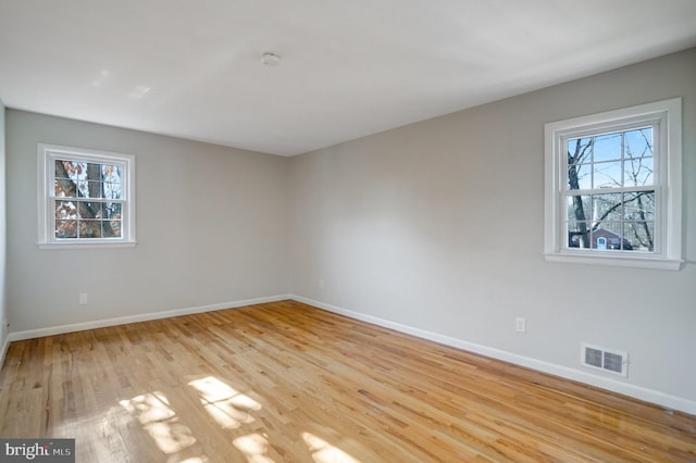 unfurnished room with light wood-type flooring