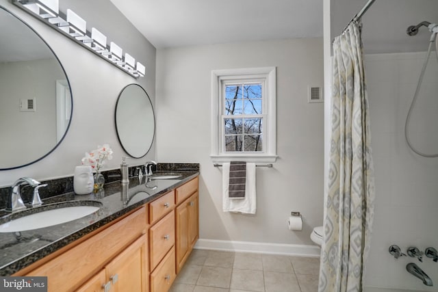 bathroom featuring vanity, tile patterned flooring, and toilet