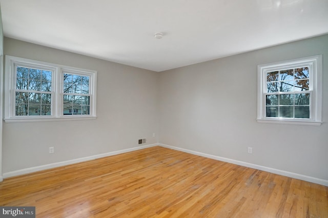 spare room with light hardwood / wood-style floors