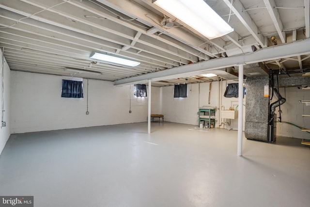 basement featuring sink and heating unit