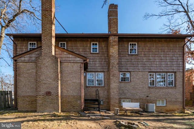 back of house with central AC unit