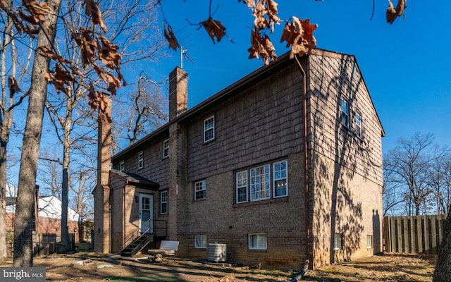 rear view of house with central AC unit