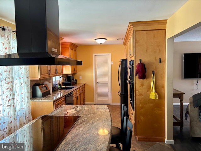 kitchen with sink, extractor fan, light tile patterned floors, black dishwasher, and stone counters