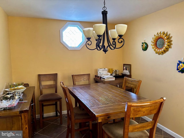 tiled dining room featuring an inviting chandelier