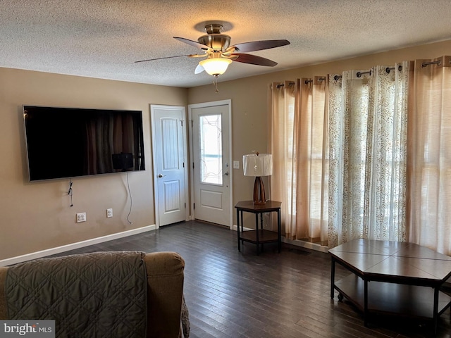 entrance foyer with ceiling fan, dark hardwood / wood-style floors, and a textured ceiling