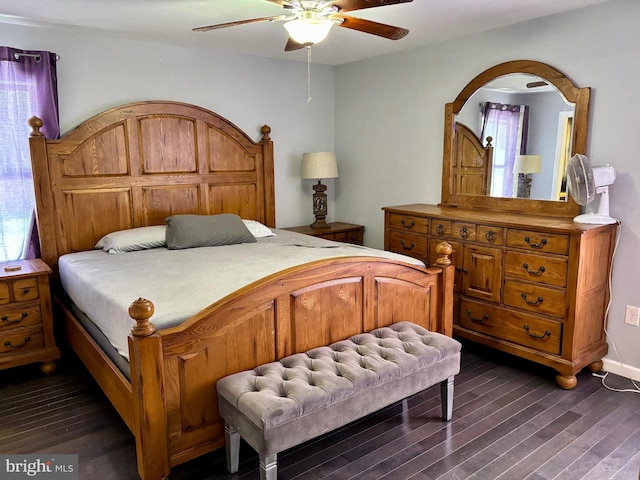 bedroom featuring dark wood-type flooring, ceiling fan, and multiple windows