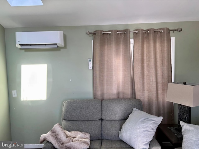 sitting room with a wall unit AC and a skylight