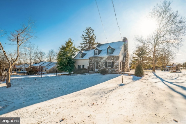 view of snow covered rear of property